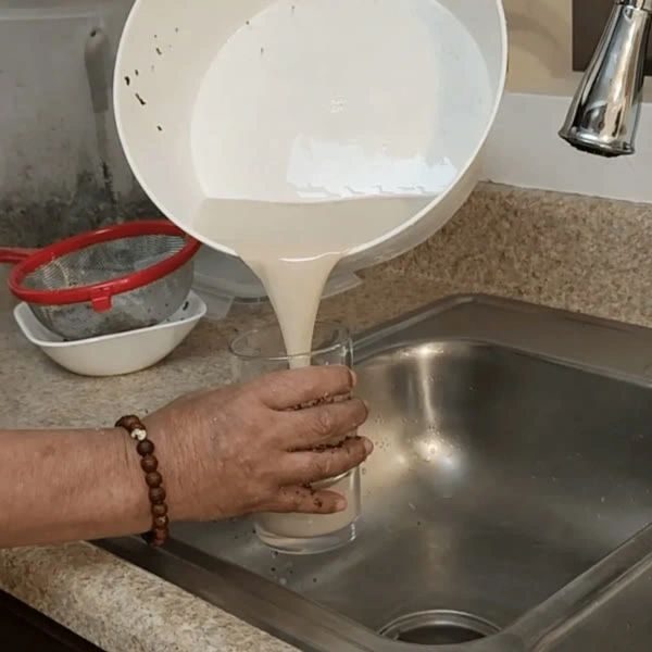 Pouring freshly brewed Chhaang into a glass