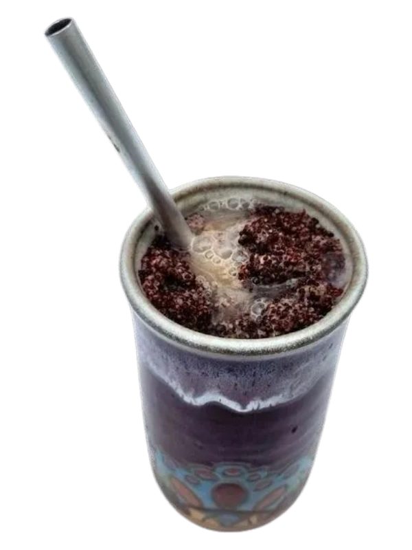 Tongba served in a ceramic vessel with a Pipsing straw